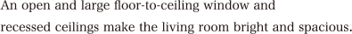 An open and large floor-to-ceiling window and recessed ceilings make the living room bright and spacious.